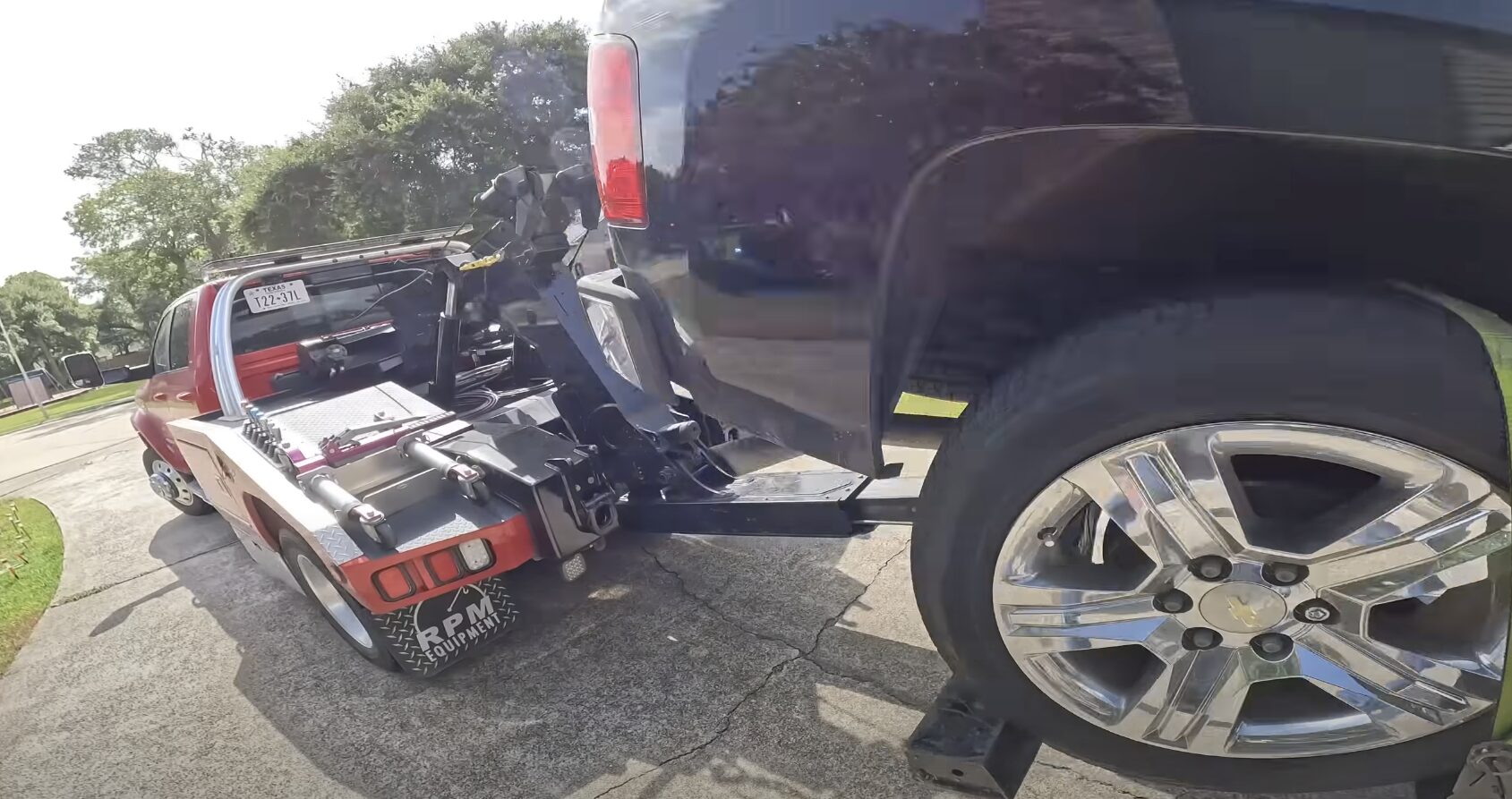 Accident Recovery - Professional Vehicle Securing and Transport Tow truck driver securing damaged vehicle during professional accident recovery