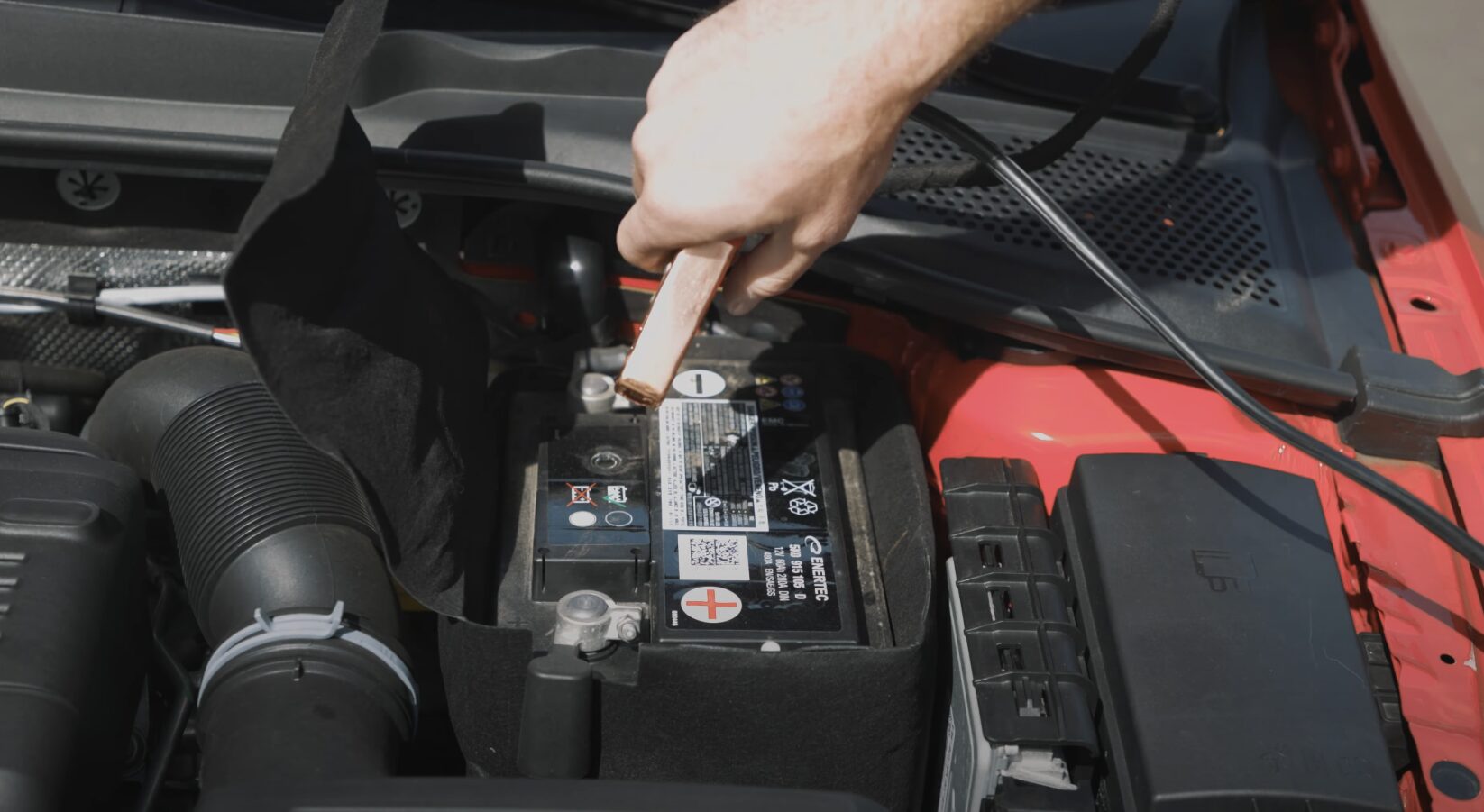 Roadside Assistance - Jump Starts, Tire Changes, and More Roadside assistance technician providing battery jump start service
